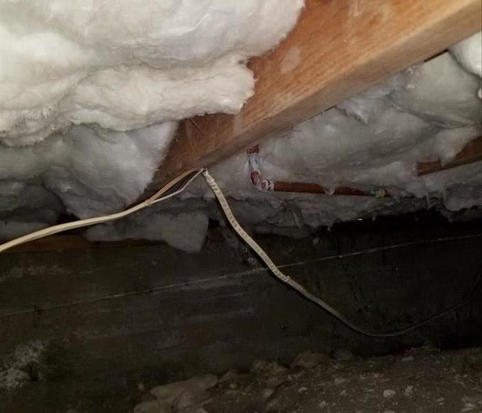 Insulation in the crawlspace that is dirty.