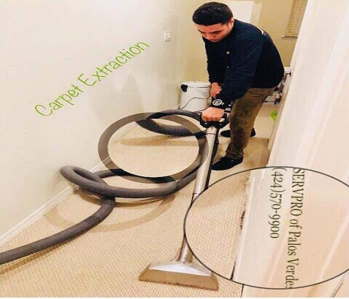 Our skillful technician using the cleaning extractor machine on carpet.