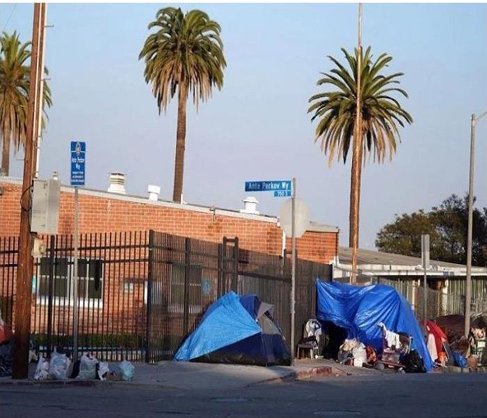 Street Corner with blue tents set up for the homeless
