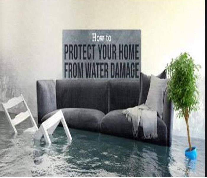Grey Loveseat with white wooden chair that is engulfed in about a foot of standing water. 